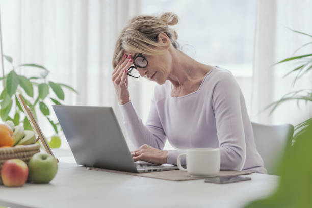 istock Tired woman working from home 1410797120