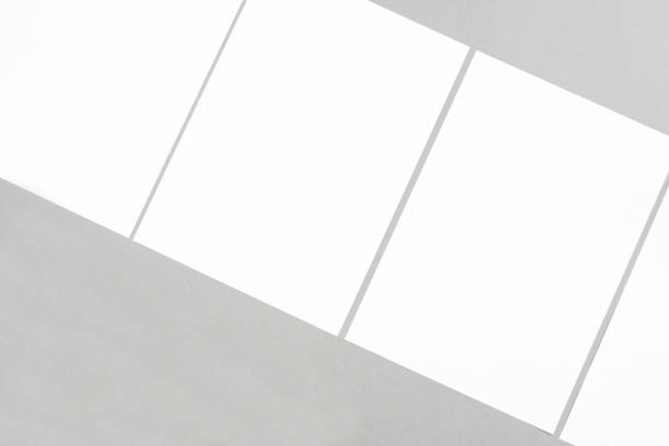 istock Empty white rectangle poster mockups lying diagonally on a gray background 1410798158