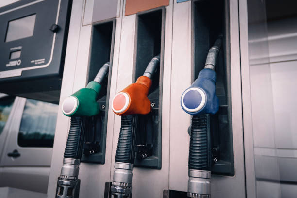 refueling gun close-up. various colored refueling pistols. rise in the price of gasoline - gas station fuel pump station gasoline imagens e fotografias de stock