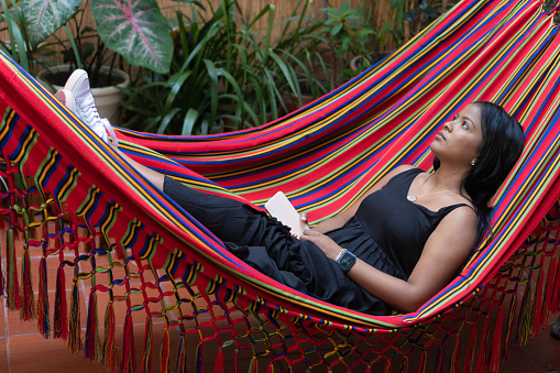 Young woman resting in a hammock