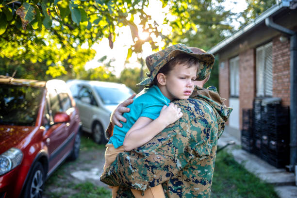 istock Male soldier is welcomed home by his son. 1410803832