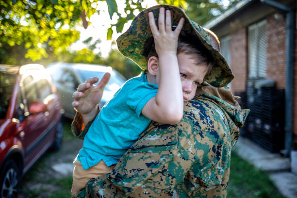 istock Male soldier hugging young son 1410803890