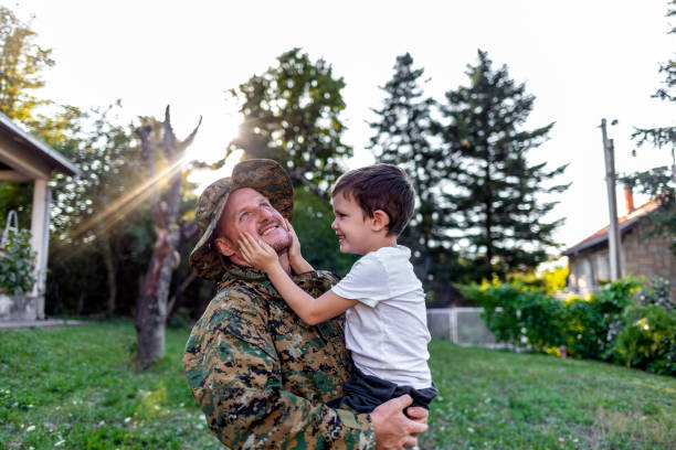istock Playful military man having fun with his small son at home. 1410804568