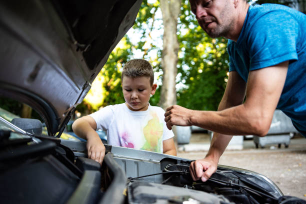 istock Father and son repair a car 1410806693
