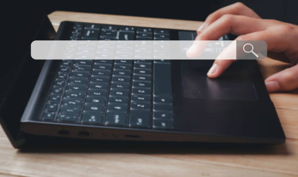 istock Search Browsing Internet hand working on modern laptop at table indoors, closeup 1410808678