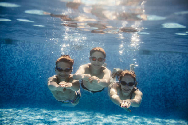 istock Teenagers playing underwater in pool 1410811722