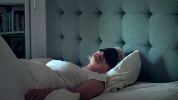 istock Exhausted, mature woman sleeping in eye mask 1410814914