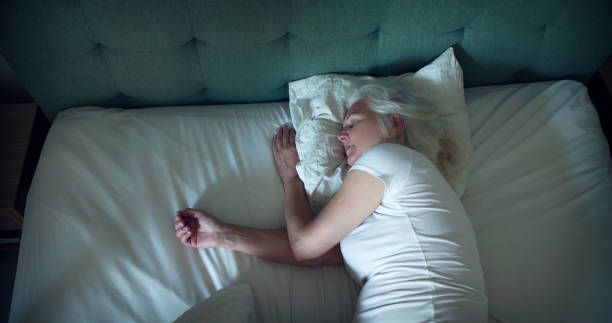 istock Mature woman sleeping in comfortable bed. Relaxing after fighting over insomnia 1410815503