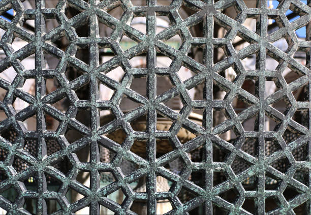 istock Old metal patterned lattice on a window or door, close-up, interesting background 1410815655