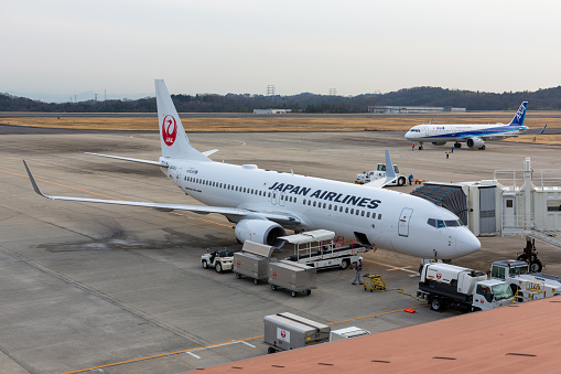 Okayama, Japan - February 7, 2020 : Japan Airlines and All Nippon Airways aeroplanes at Okayama Momotaro Airport in Okayama, Japan.