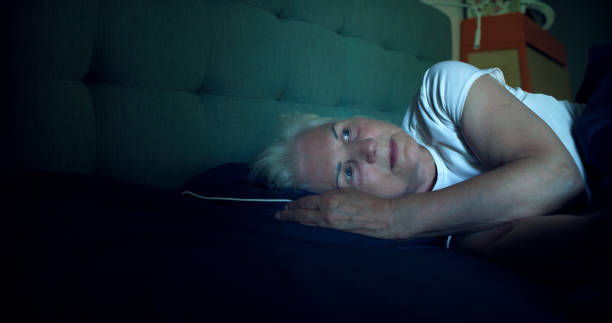 istock Anxious, mature woman trying to sleep at night. Dealing with sleeping disorder 1410816111
