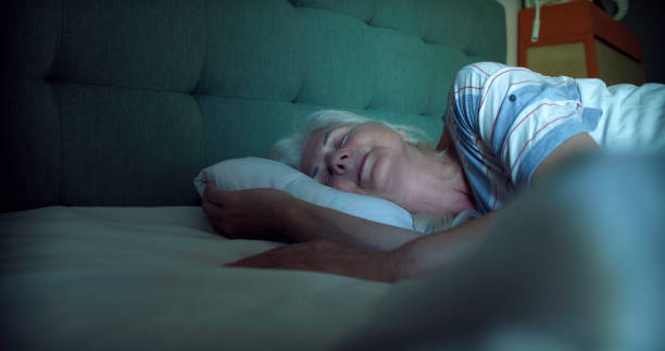 istock Mature woman falling asleep at night. Dealing with sleeping disorder 1410816115