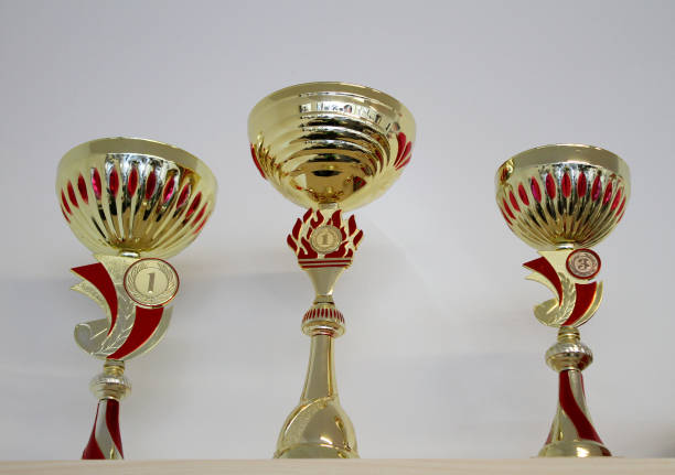 istock Golden sports cups for winning competitions on a shelf 1410816228
