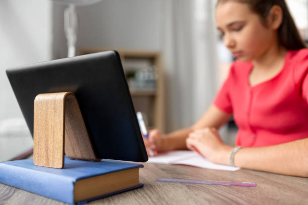 istock tablet pc and student girl learning at home 1410817585