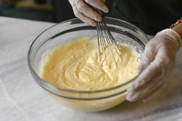 istock A hand in rubber glove stirring dough for a cake 1410818272