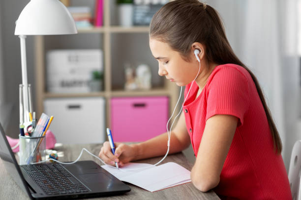 istock student girl in earphones learning at home 1410820501