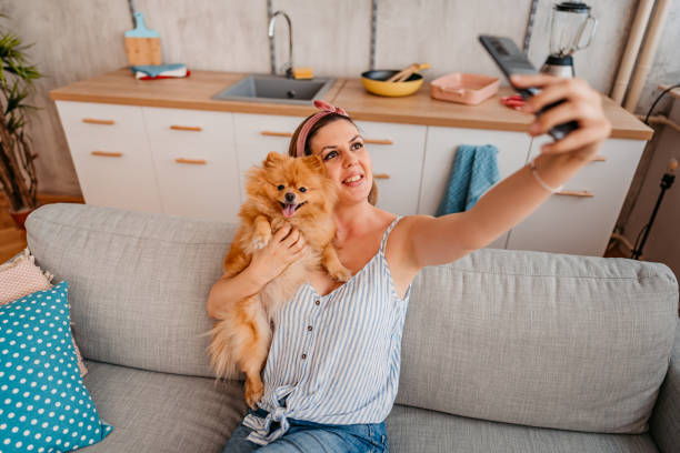 istock Young Woman Taking A Selfie With Her Dog 1410822536