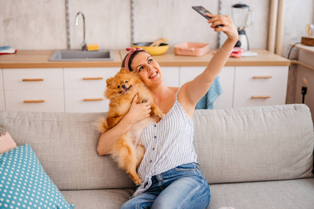 istock Young Woman Taking A Selfie With Her Dog 1410822711