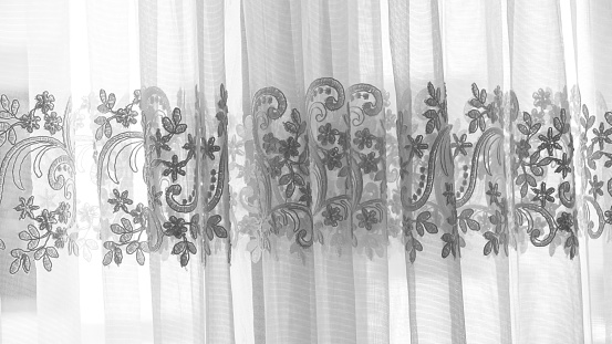 Lace detail of a tulle curtain black and white