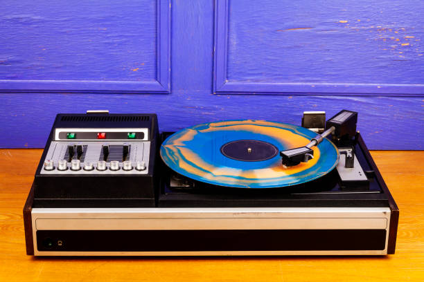 istock Vintage turntable vinyl record player with blue and orange vinyl 1410823959