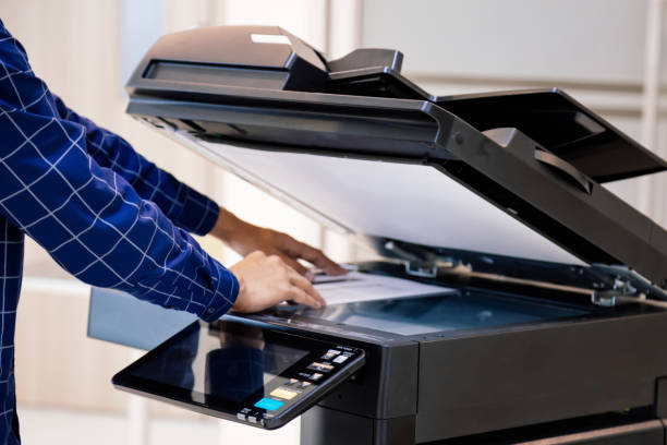 istock Businessmen press button on the panel for using photocopier or printer for printout and scanning document paper at office. 1410824487