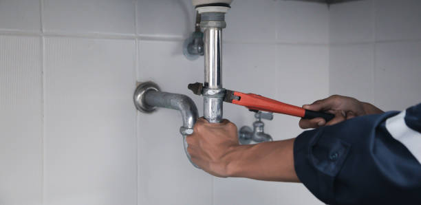 istock Male Plumber Using Wrench To Fix Leaking Sink In Home Bathroom. 1410825009