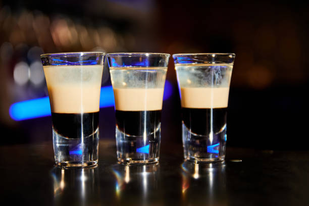 A set of shots b-52 from coffee liqueur, Irish cream and orange liqueur A set of shots b-52 from coffee liqueur, Irish cream and orange liqueur coffee liqueur stock pictures, royalty-free photos & images