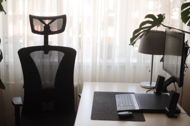 istock Home office with curved screen and orthopaedic chair.Interior with plants 1410825775