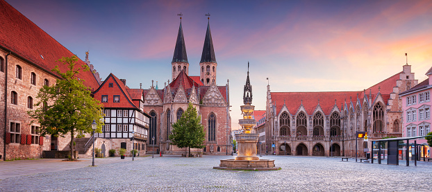 Panoramic cityscape image of historical downtown of Brunswick, Germany with St. Martini Church and Old Town Hall at summer sunset.