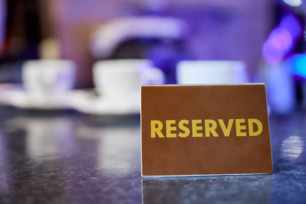 Plastic plaque with the inscription Reserved on the restaurant table