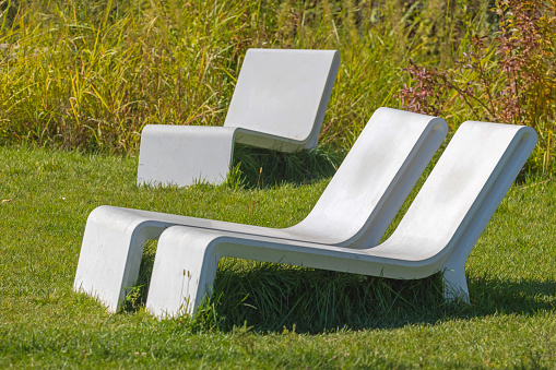 White Furniture at Grass in Garden at Sunny Day