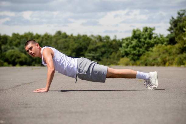 istock A Nineteen Year Old Teenage Boy Doing Push Ups A Public Park 1410829018
