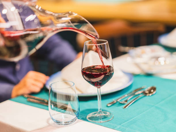 istock while the waiter pours red wine 1410829085