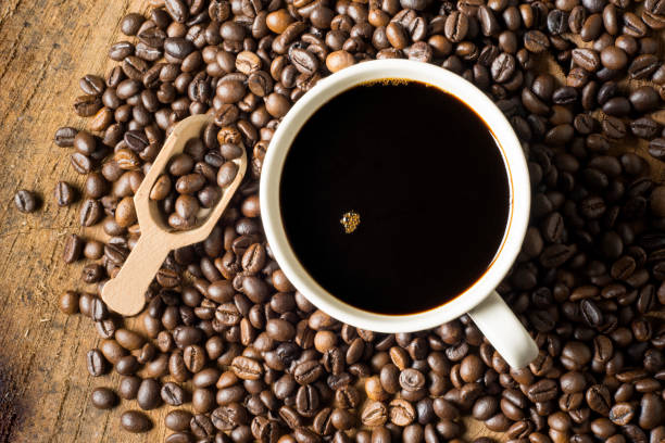 istock Black coffee in a white ceramic mug. on the ground coffee beans. soft focus.shallow focus effect. 1410829848