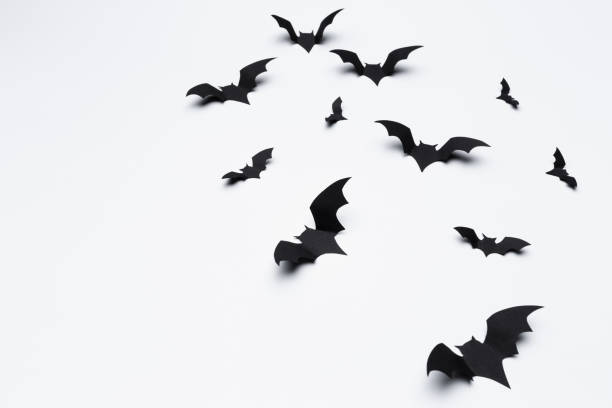 istock halloween and decoration concept - paper bats flying 1410830891