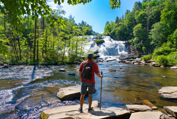 istock Man hiker relaxing by the waterfall. 1410831587
