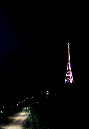 Road and glowing tower. Street lights and tower