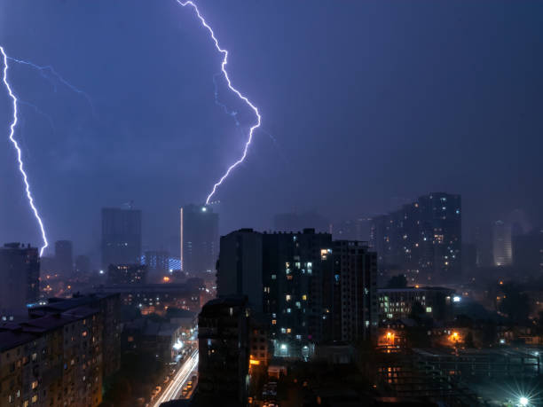 istock lighting strike thunderstorm weather over night city. long exposure scene 1410832072