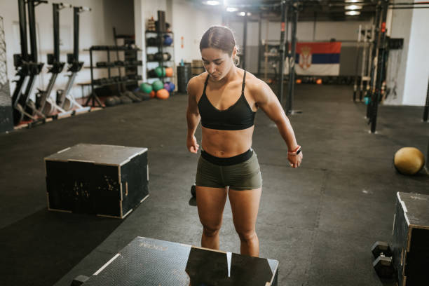 istock Strong young woman doing box jump exercise during training 1410832150