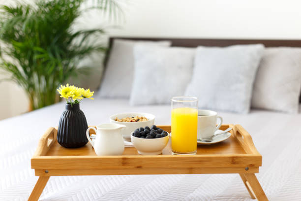 istock Wooden tray with breakfast on the bed 1410832220