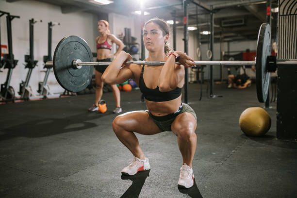 istock Young female athlete exercising with weights 1410832590