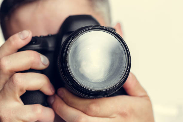 istock photographer with camera in hand 1410832629
