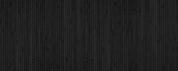 Black bamboo slat wide texture. Abstract wooden backdrop. Textured wood plank dark background Black bamboo slat wide texture. Abstract wooden backdrop. Textured wood plank dark background wood panelling stock pictures, royalty-free photos & images