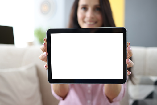 Woman is holding black tablet on advertising banner. Applications for gadgets concept