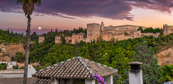 View of the Alhambra at dusk from the viewpoint of San Nicolas in Granada, Spain