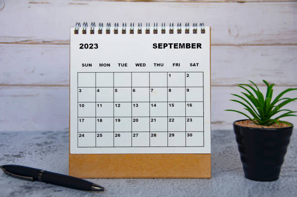 istock September 2023 desk calendar with table plant and pen. 1410835680