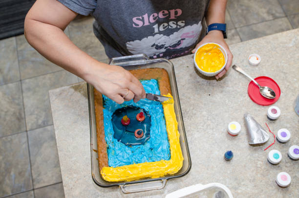 istock Mature woman icing a special birthday cake 1410836145