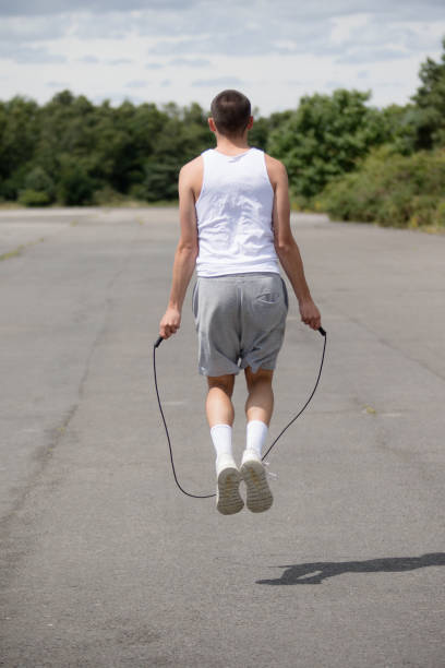 istock A Nineteen Year Old Teenage Boy Using A Skipping Rope in A Public Park 1410837247