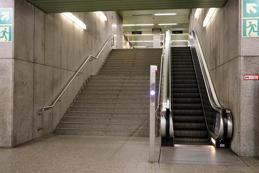 Empty stairway and escalator at a subway station