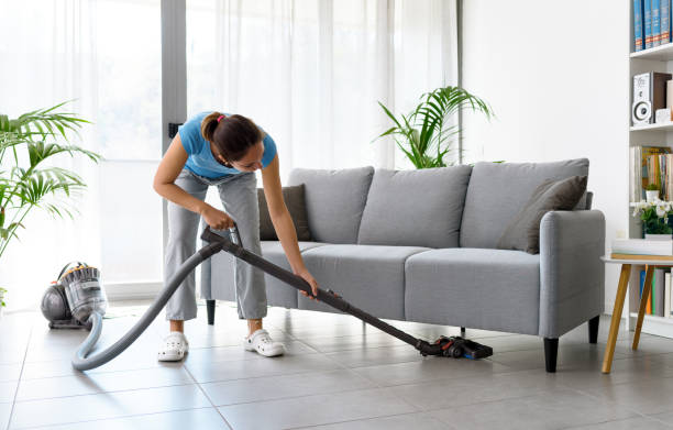 istock Woman vacuuming the floor at home 1410837514